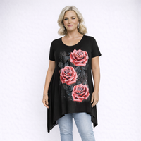 Woman wearing a black t-shirt with pink rose designs on a white background