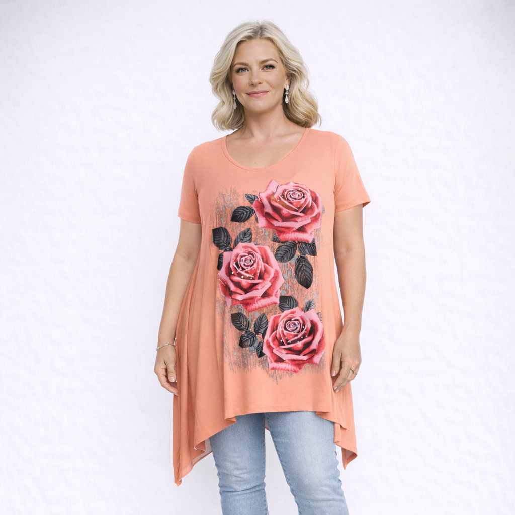 Woman wearing a peach-colored t-shirt with pink rose designs on a white background