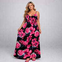 Woman wearing a floral dress with pink flowers on a black background