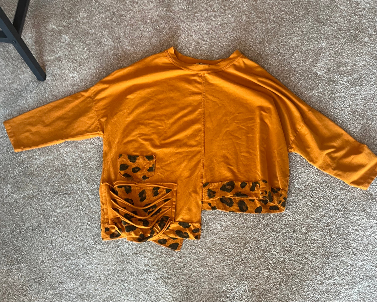 Orange top with leopard print on the bottom