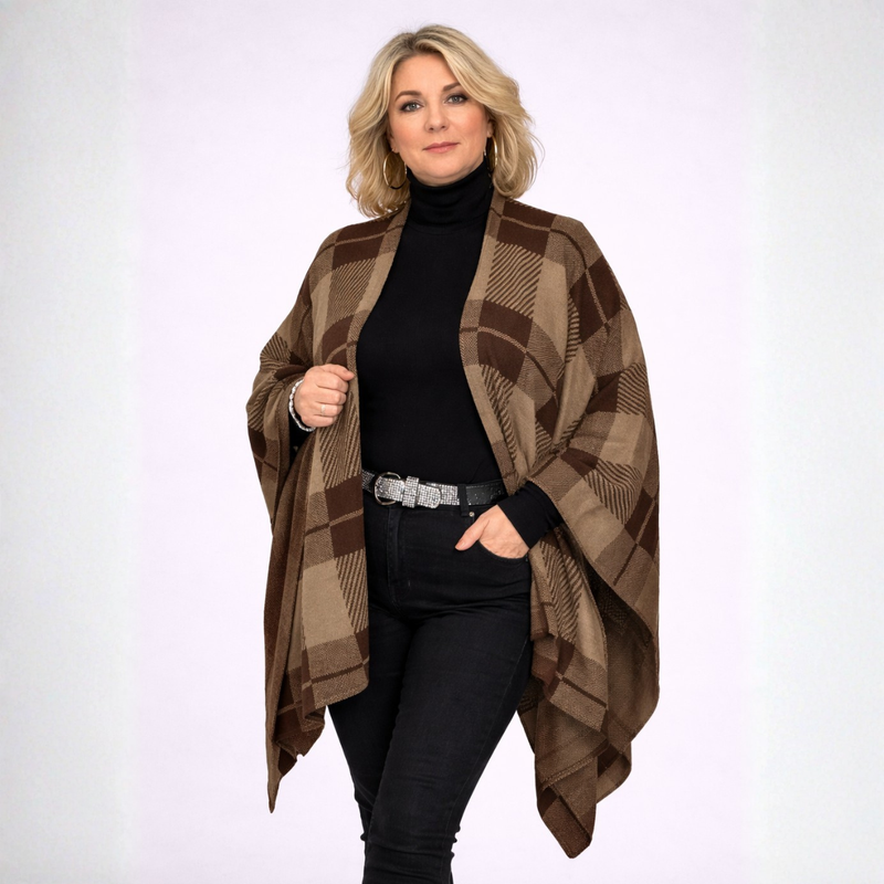 Woman wearing a brown plaid shawl over a black outfit on a white background