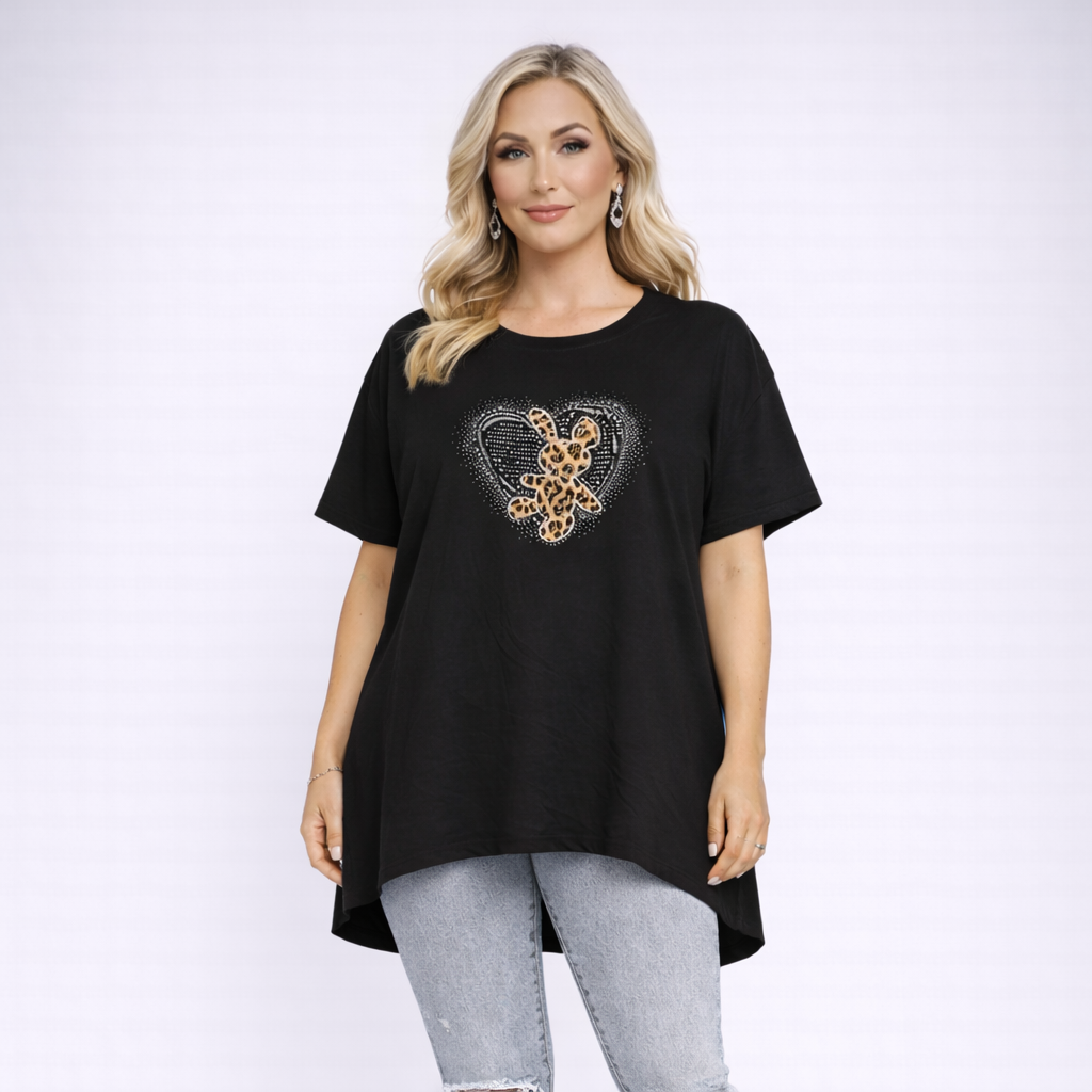 Woman wearing a black t-shirt with a leopard print heart design on a white background