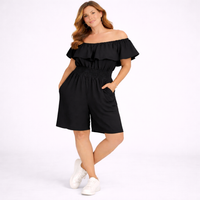 Woman wearing a black off-shoulder romper on a white background