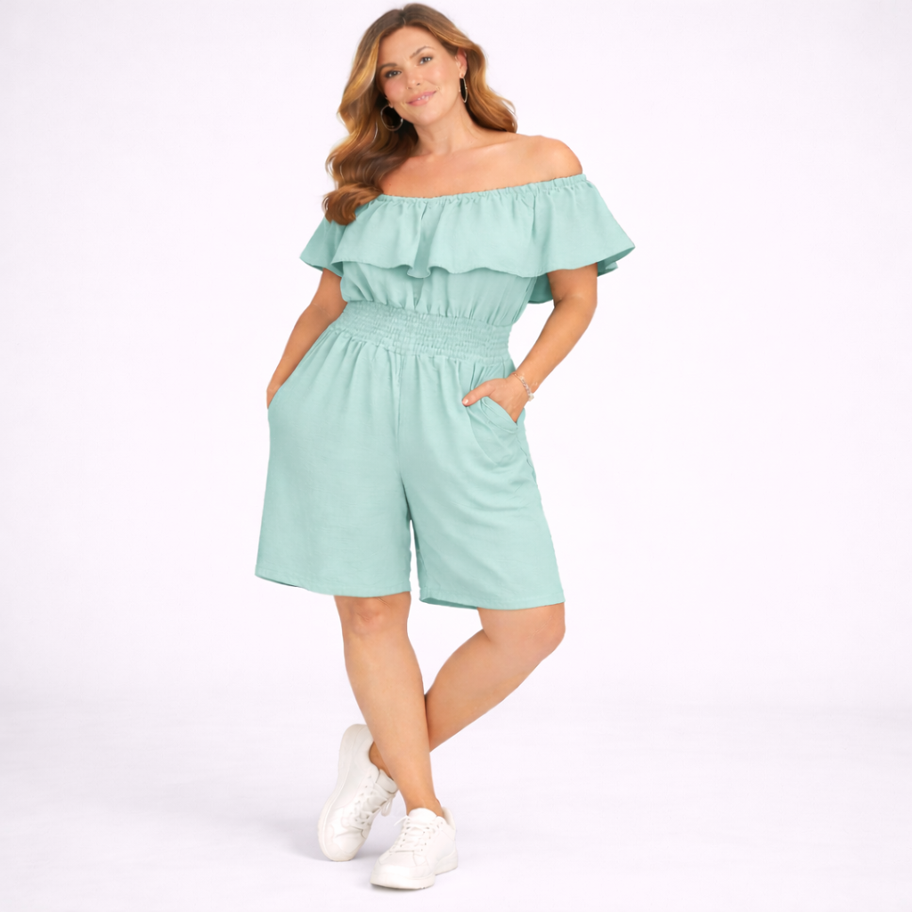 Woman wearing a light blue off-shoulder romper on a white background