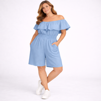 Woman wearing a light blue off-shoulder romper on a white background