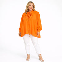 Dipped Hem Tie Neck Loose Fitting Blouse