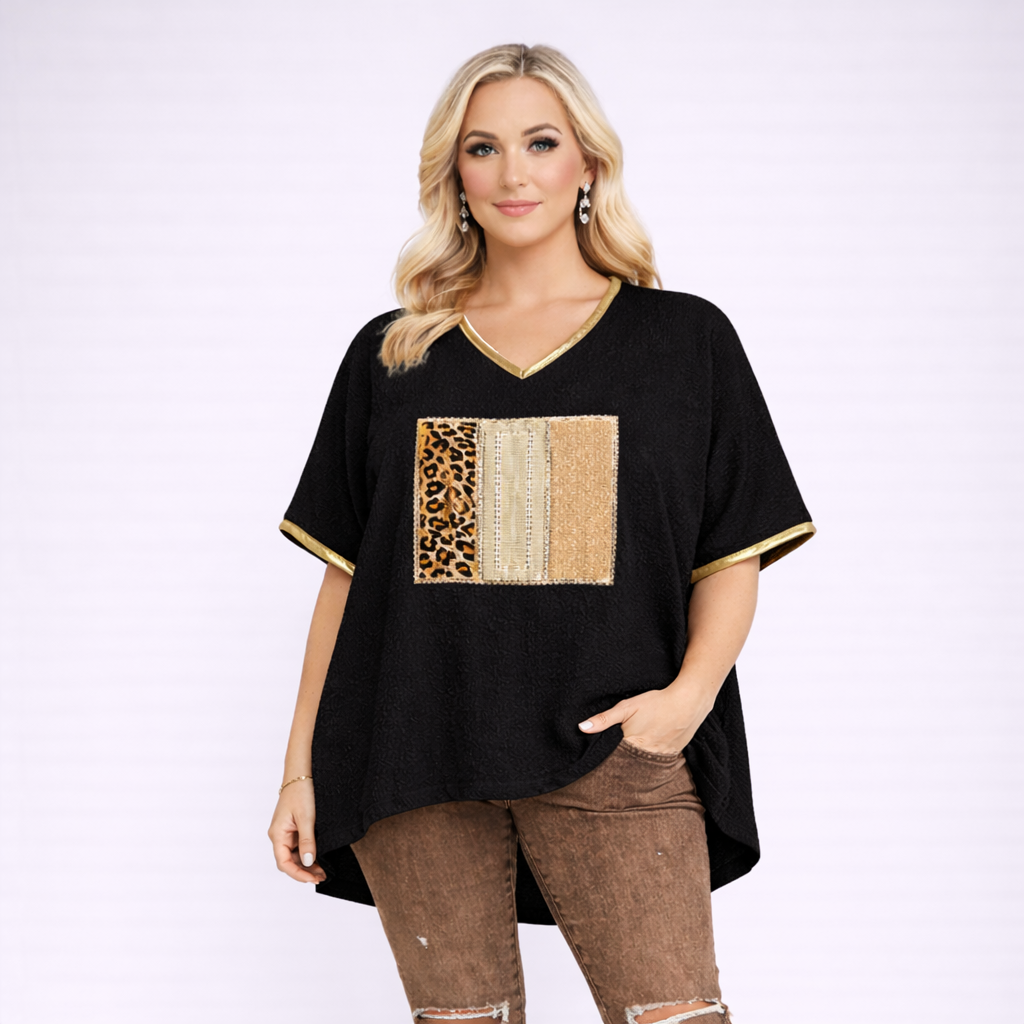 Woman wearing a black top with a colorful patch design on a white background