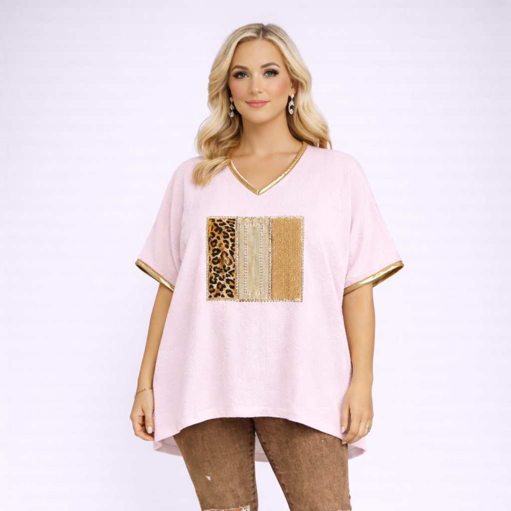 Woman wearing a pink top with leopard print and gold accents on a white background