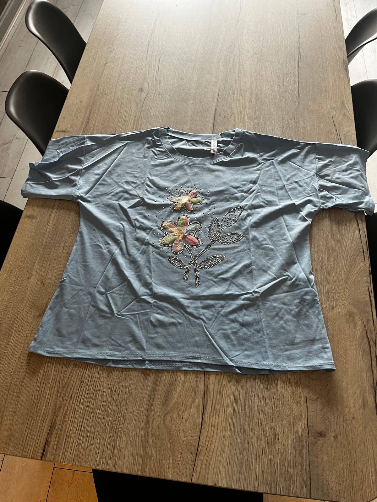 sky blue top with floral print on front