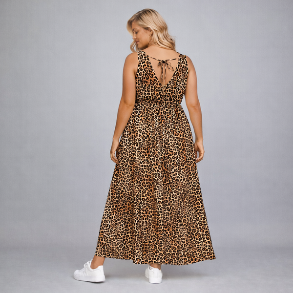 Woman wearing a leopard print dress on a gray background