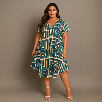 Woman wearing a patterned dress against a plain background