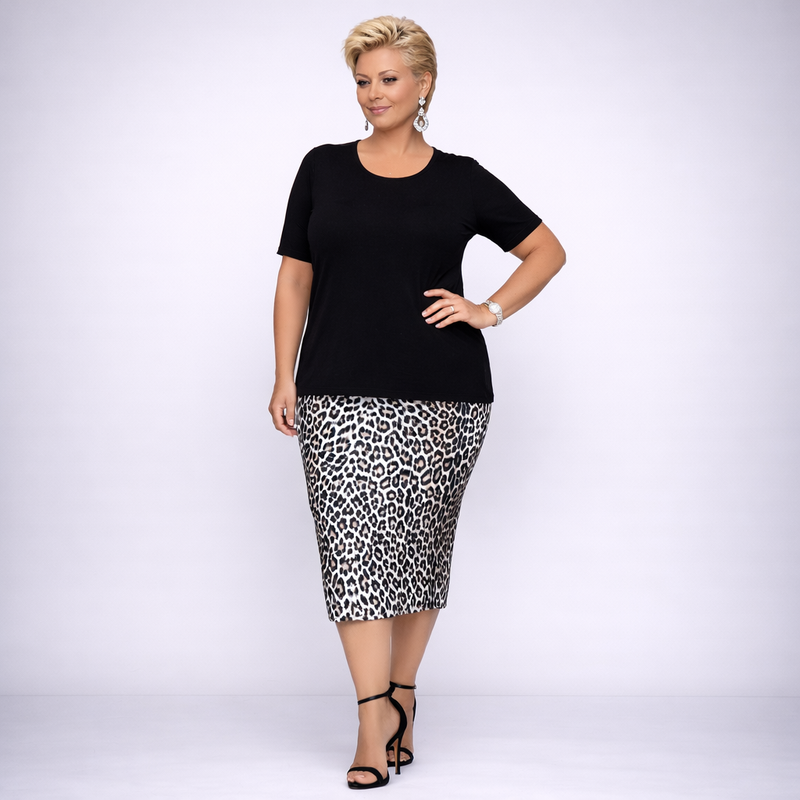 Woman wearing a black top and leopard print skirt on a white background