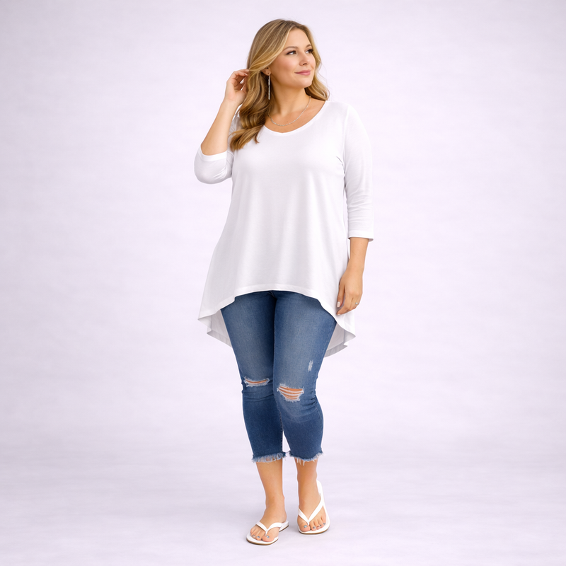 Woman wearing a white long-sleeve top and blue jeans on a white background