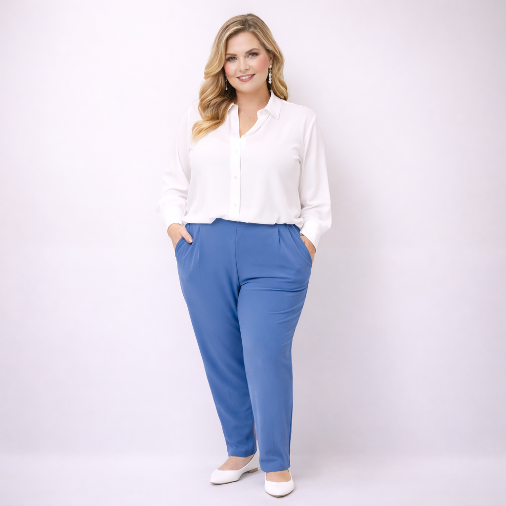 Woman wearing a white blouse and blue pants on a white background