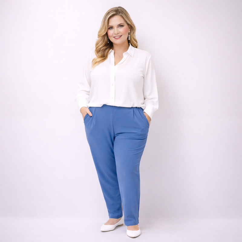 Woman wearing a white blouse and blue pants on a white background